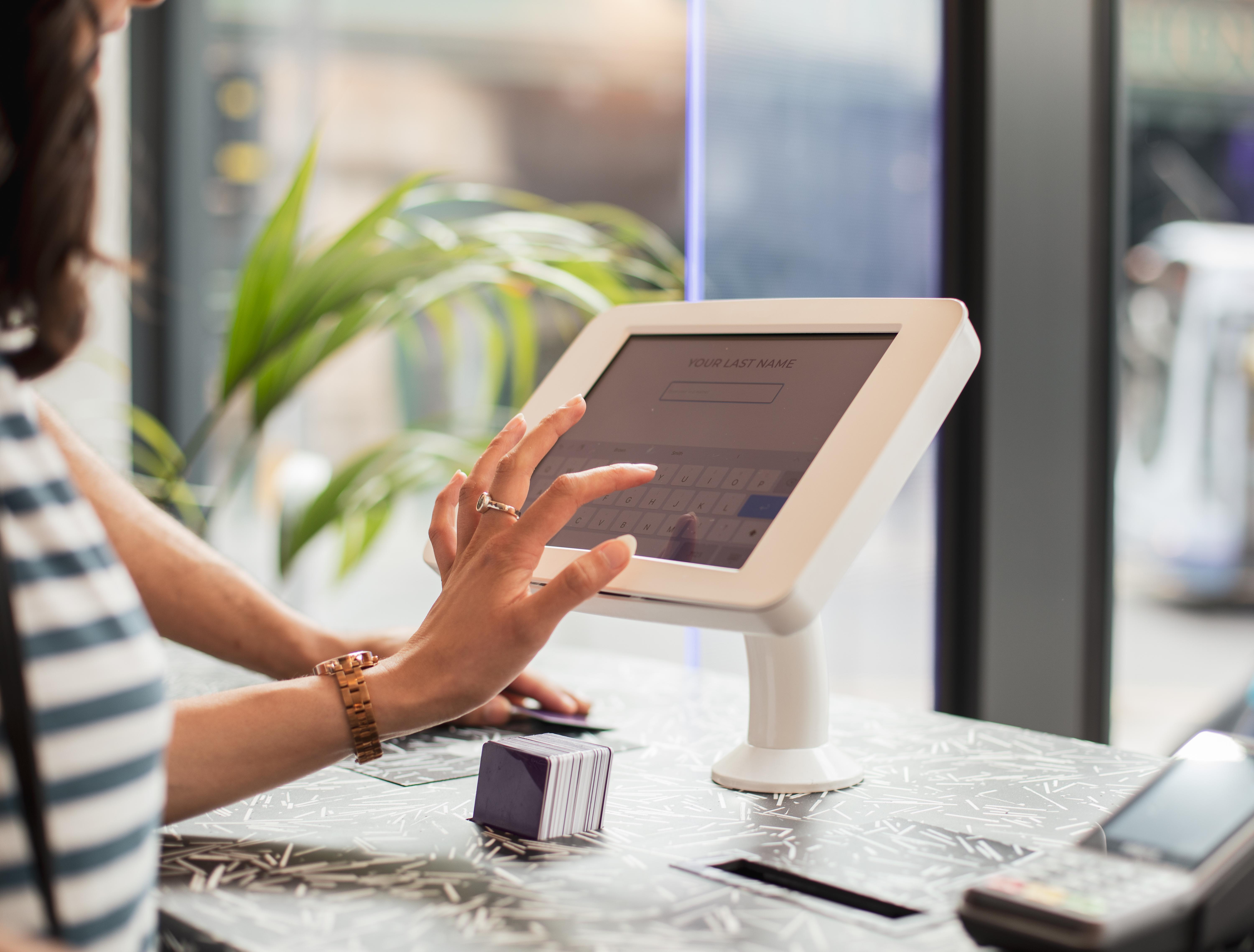Yotel กลาสโกว์ ภายนอก รูปภาพ A woman using a tablet to enter her name at a check-in desk